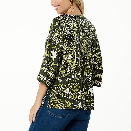 Colleen Lopez Woven Relaxed Fit Printed Top  This easy-breezy woven top features an amazing print that's sure to complement your style. It perfectly pairs with just about any pant, legging or skirt. Patterned V-neck Tops For Vacation, Green V-neck Top With Vibrant Print, Chic V-neck Top With Bold Print, Patterned Abstract Print V-neck Top, Green Printed Crew Neck Blouse, Printed Tops For Day Out In Fall, Patterned Blouse With Bold Print, V-neck Beach Top With Abstract Print, Cotton V-neck Top With All Over Print