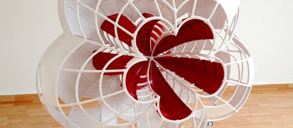 a red and white fan sitting on top of a hard wood floor