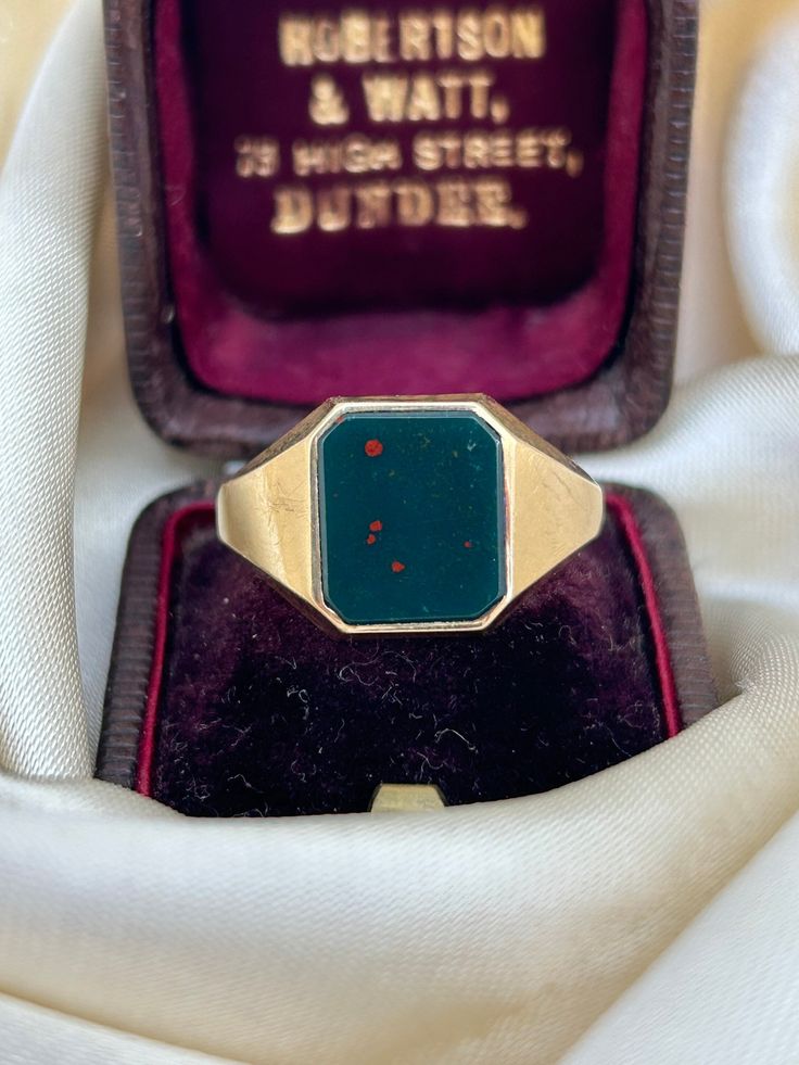 Chunky Charles Green and Son Bloodstone Gold Signet Ring  chunky and gorgeous!  The item comes without the box in the photos but will be presented in a gembank1973 gift box   Measurements: Weight 7.38g, size UK R1/2 US 83/4, head of ring 13mm x 11mm, height off finger 2mm  Materials:  gold and bloodstone   Hallmarks: hallmarked 375 Condition : The overall condition is very good office use: DC2 Gold Art Deco Enamel Ring For Gift, Vintage Gold Enamel Ring With Gemstone, Vintage Yellow Gold Enamel Ring With Gemstone, Vintage Hallmarked Rings For Memorial, Vintage Gold Signet Ring With Gemstone, Vintage Enamel Ring With Polished Finish For Formal Occasions, Vintage Gemstone Signet Ring, Vintage Round Gemstone Signet Ring, Rectangular 14k Stamped Signet Ring Collectible