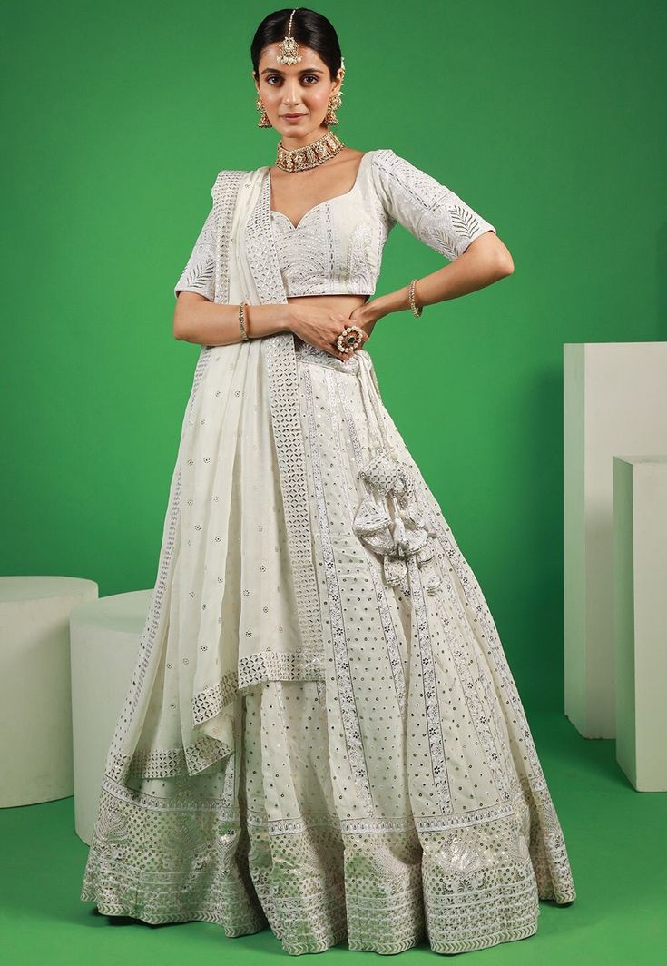 Readymade Embroidered Faux Georgette Lehenga in Off-White This attire with Cotton Lining is Enhanced with Resham, Zari, Mukesh and Sequins Work . Crafted in Sweetheart Neck and Half Sleeve. Available with a Faux Georgette Choli and a Faux Georgette Dupatta in Off-White The Choli and Lehenga Length are 12 to 15 and 42 inches respectively Do note: Accessories shown in the image are for presentation purposes only.(Slight variation in actual color vs. image is possible). We sell all kinds of Lehenga White Bollywood Choli With Zari Work, White Semi-stitched Choli With Zari Work, Semi-stitched White Choli With Zari Work, Festive White Choli With Resham Embroidery, Festive Off White Embellished Sets, Festive Embellished Off White Sets, Festive Off-white Embellished Sets, White Choli With Zari Work In Traditional Drape, White Choli With Zari Work In Traditional Style