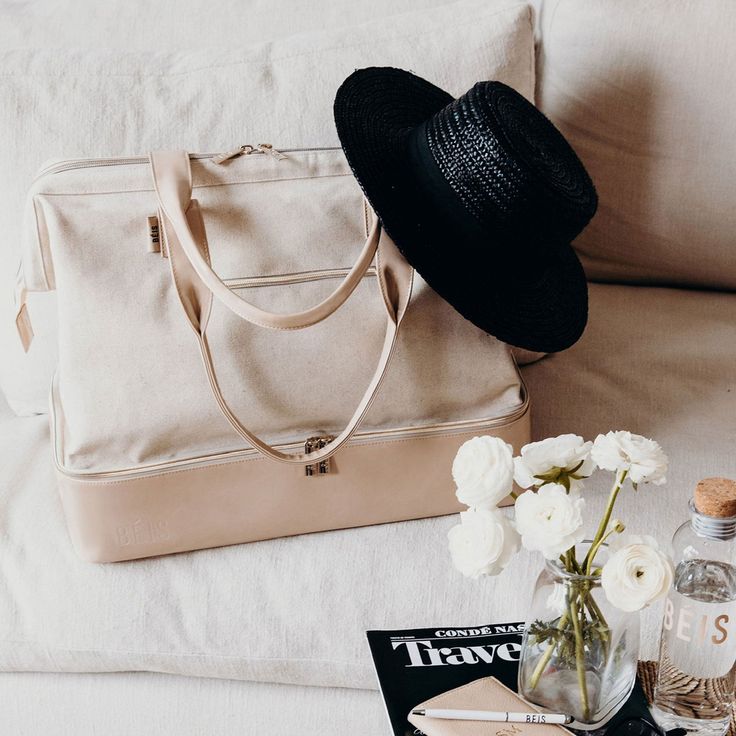 Our beige weekender bag is the ultimate travel companion. Easy packing, a separate shoe compartment + adjustable shoulder strap. Shop today! Weekend Duffle Bag, Bottle Sling, Easy Packing, Beige Bag, Dog Clip, Shay Mitchell, Laptop Pocket, Overnight Bag, Weekend Getaway