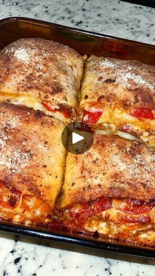 a pan filled with pizza sitting on top of a counter