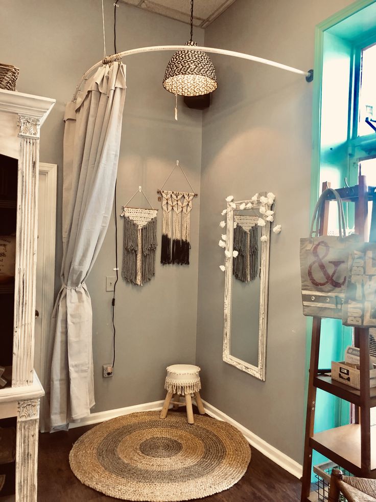 a bathroom with a round rug and mirrors on the wall, along with other accessories