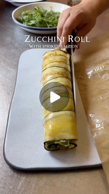 a person is cutting up some food on a tray