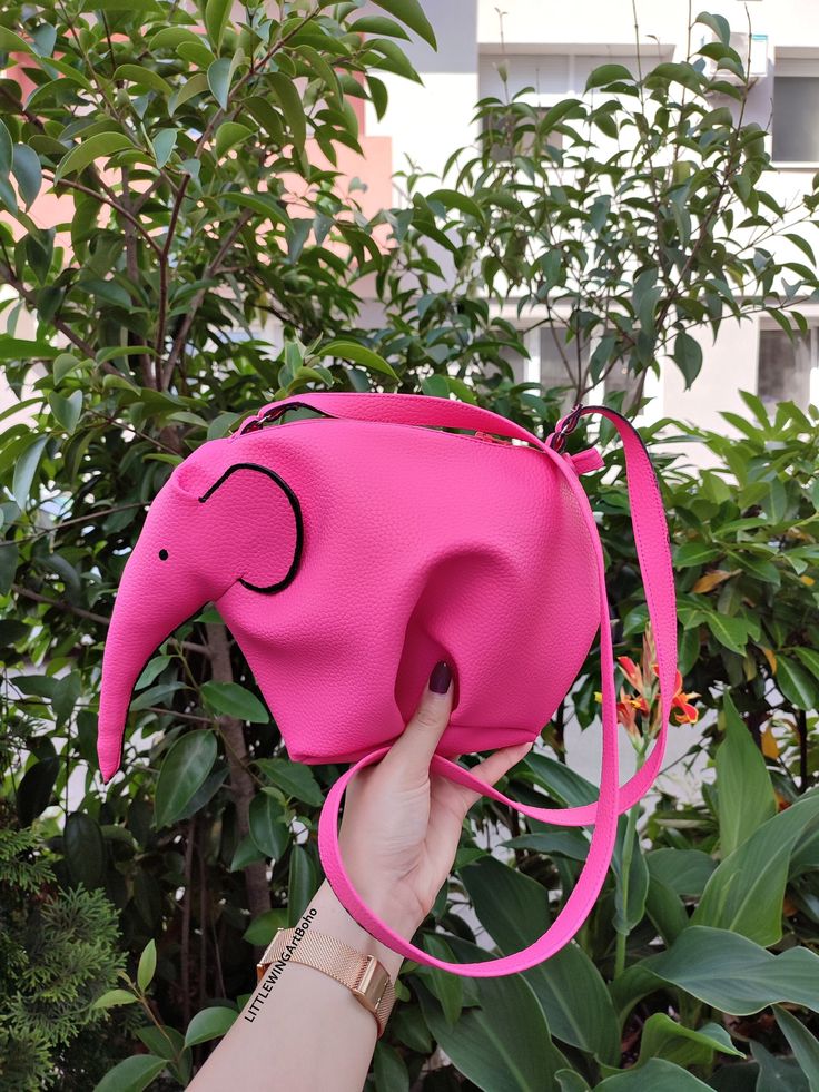 ♥Limited edition! This listing is for one PINK - ECO leather elephant bag! One of the best accessories bohemian cross-body bag is truly unique! Perfect for your personal objects, coins, decorative objects, jewelry, or other valuable items and accessories such as electronic devices (smartphones, chargers...) This clutch is very strong and durable, fashionable, classic but very stylish, perfect for your daily life, for a unique look, special occasions or events, etc. This is my favorite purse, perfect for summer days and summer nights. A zipper top. This zipper bag is highly versatile! Use it as a wallet, for makeup, or a small bag for an evening walk. 100% Handmade * Ready To Ship * This bag has been made with love and attention. Height: 21 cm ( 8 in ) Width: 30 cm ( 11 in ) Depth: 18 cm ( Pink Mobile Phone Bag For Travel, Pink Handheld Satchel, Pink Backpack With Phone Pocket, Pink Backpack With Mobile Phone Bag, Pink Handheld Portable Satchel, Pink Backpack With Mobile Phone Pocket, Pink Mobile Phone Bag For School, Pink Handheld Shoulder Bag For School, Pink Portable Shoulder Bag