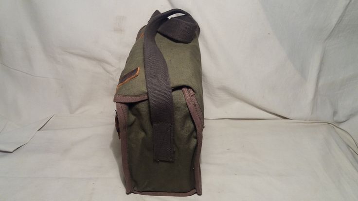 Vintage 1980's military green canvas bag - shoulder bag - NEW. Measurements: H - 10'' [ 25cm.] W - 10'' [ 25cm.] Side - 5'' [ 12.5cm.] One section and one pocket inside. Leather clasps.Adjustable canvas long handle - max.39 2/5'' [100cm.] UNUSED. NOTE: All vintage items in my shop that are used have been restored according to the possibilities All defects are removed,except the normal signs of use over the years. Thank you and successful shopping. Military Style Outdoor Satchel Bag, Military Style Satchel Bag For Outdoor, Outdoor Military Satchel Bag, Military Style Satchel For Outdoor, Canvas Satchel In Khaki For School, Vintage Green Canvas Bag For Travel, Khaki Canvas School Satchel, Green Rectangular Canvas Bag For Outdoor, Vintage Khaki Rectangular Shoulder Bag