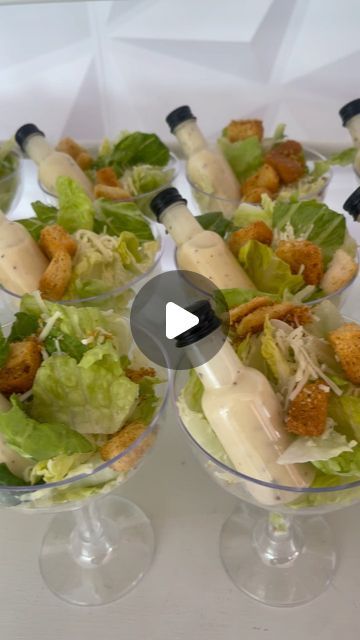 several small glass bowls filled with salads and dressing on top of a white table