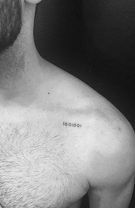 a shirtless man with the word tattoo on his chest