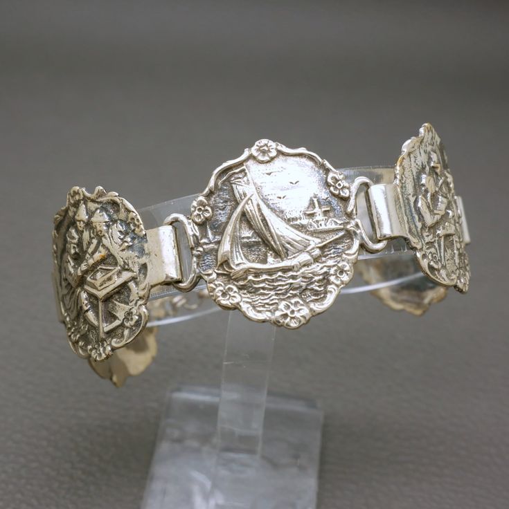 Antique Dutch handcrafted 835 silver bracelet, dating to 1920s. The bracelet is crafted of five elaborately detailed medallions, which are featuring different old Dutch genre scenes from the paintings of Jan Stein.  Beautiful and rare piece of jewelry with lots of individual character, suitable for any occasion, will look very stylish with modern outfit. The bracelet will be shipped in a gift box. Length:  7" (18 cm) - it would fit a medium wrist. Bracelet width: 1 1/8" (2.9 cm)  Weight: 30.7 gr Traditional Dutch Jewelry, Dutch Heritage, Heritage Jewellery, Old Dutch, Wrist Bracelet, Traditional Jewelry, Modern Outfits, Chain Link Bracelet, Link Bracelets