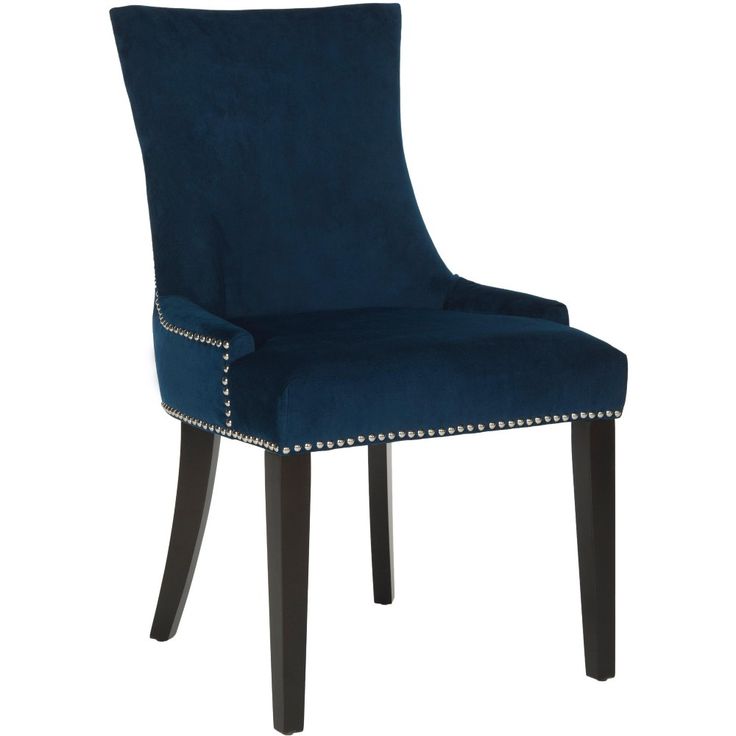 a blue velvet dining chair with studded trim