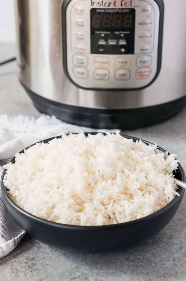 rice in a bowl next to an instant pot