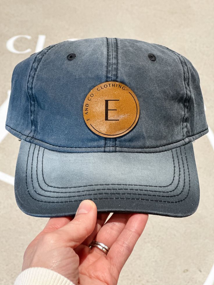 Women's Acid Washed Adjustable Baseball Cap E AND CO. CLOTHING BASEBALL CAP Introducing the E and Co. Baseball Cap: the perfect blend of signature style and casual comfort for all your summer days. Show off your love for the brand while staying cool and stylish. Upgrade your look with this must-have accessory. Take a look at our other hats and accessories HERE! Details One size Women's Acid Washed Adjustable Baseball Cap Color option: Black Acid Wash Leather patch Adjustable 100% Cotton Hats are final sale and cannot be exchanged or returned Luxury Cotton Curved Brim Baseball Cap, Everyday Trucker Hat Baseball Cap, Gray Curved Bill Baseball Cap For Everyday, Adjustable Gray Baseball Cap For Everyday, Outdoor Logo Patch Baseball Visor Cap, Adjustable Baseball Cap With Logo Patch, Everyday Snapback Hat With Curved Bill, Trendy Flat Bill Baseball Cap For Outdoor, Adjustable Visor Baseball Cap With Logo Patch