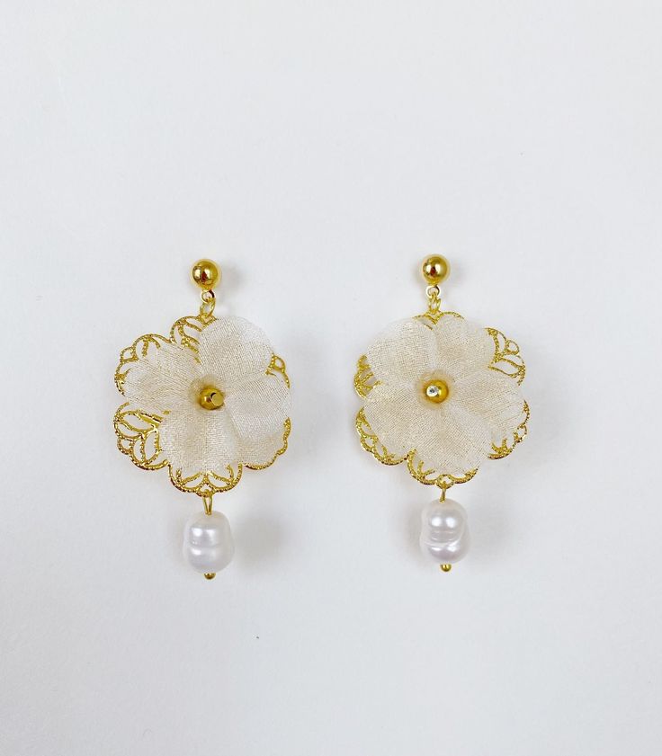 *Use discount FOURITEMS to get 10% off when you purchase 4 or more items (valid with jewelry, ceremony item, etc) * Designed and handcrafted in the Philippines by Filipino women artisans * Gold-plated brass studs with secure lock backs * Made of stainless steel gold plated hardware, handcrafted silk organza flowers characterized with sheerness that complements one's elegance, and baroque South Sea pearls, locally sourced from Cebu City in the Philippines to support traditional crafts * 2 inches in length, lightweight to wear all day * Each piece features 'intentional imperfections' - variations in exact size, cut, color, texture, and patterns. This adds to the individuality and unique story of each piece. Pearls are baroque and irregularly shaped, just as nature intended and may not exactl