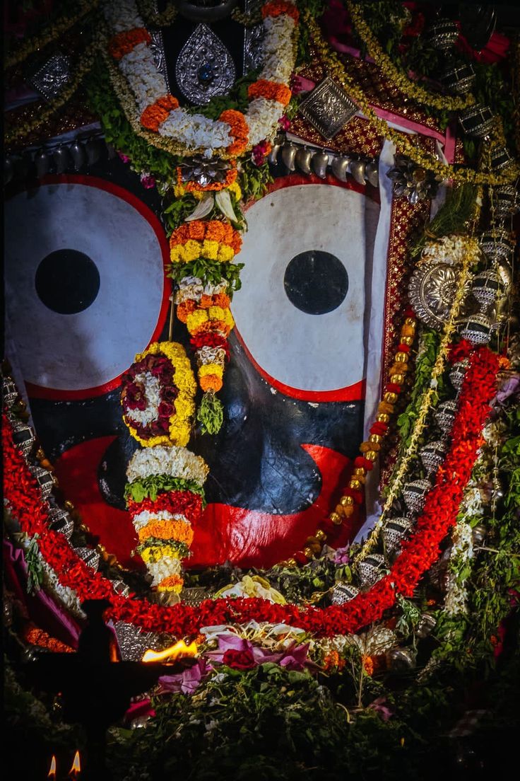 an elaborately decorated mask is shown in the dark