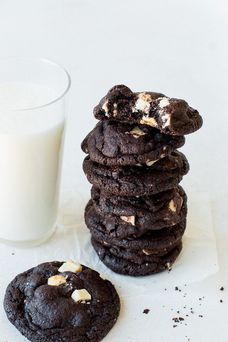 a stack of cookies next to a glass of milk