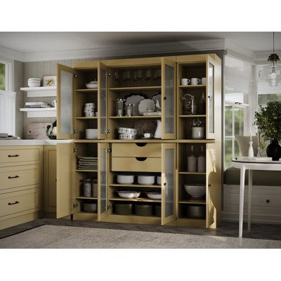 an open cabinet in the middle of a kitchen