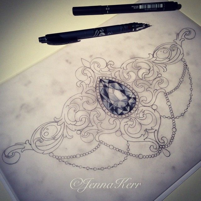 a drawing of a necklace with a diamond on it next to a black marker pen