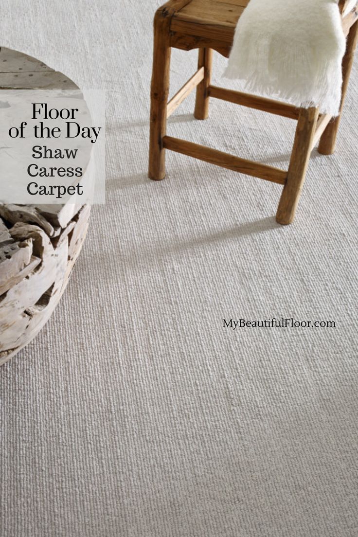 a wooden chair sitting on top of a carpet covered floor