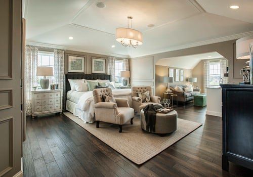 a living room filled with furniture and a large mirror on the wall above it's doorway