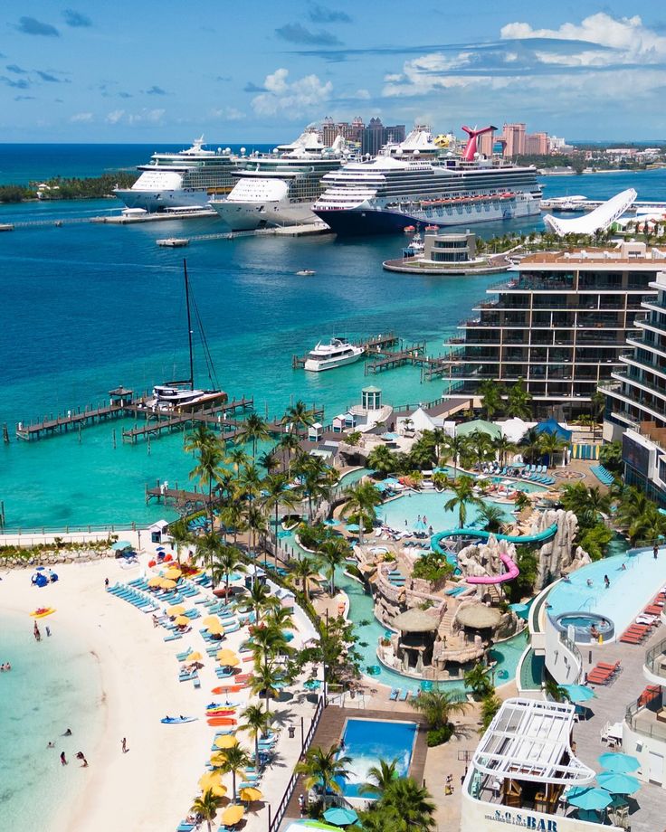 an aerial view of the beach and cruise ships