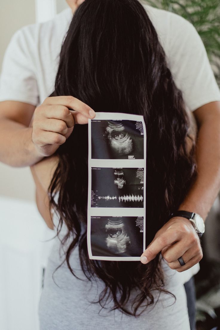 a man is holding up an image of a woman's hair