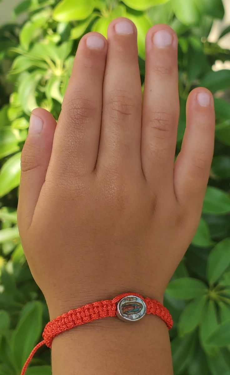 Perfect little Virgin Mary Bracelet for children! Easy to adjust to every little wrist. We recommend for children ages 3 and up. 2 Color Options Solid Red Solid Black Adjustable Bracelet Child size recommended 3+ (For Size Reference: Child model is 3 years old)