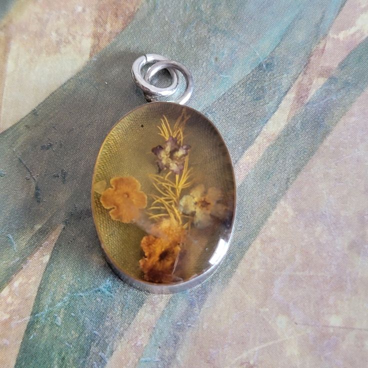 This is a vintage, sterling silver and  flower pendant. They are real flowers encased in Lucite. This piece has tested positive for sterling and was made in Mexico. All sales are final. This measures just over 1 inch in length including the bale. If you have a wish list or are looking for something specific, please ask. I may have exactly what you are looking for. As always please convo me with any questions or concerns regarding this item or with any international shipping questions. Unfortunately I do not accept returns or grant refunds. All shipping fees include handling fees. If you would like to combine shipping costs for more than one item, I would be happy to do so if you convo me before purchase. Purchasing my item means you have read, understood and will abide by my policies. Sorr Silver Flower Jewelry For Memorial, Collectible Silver Flower Jewelry, Vintage Sterling Silver Flower Necklace, Silver Pressed Flowers Memorial Jewelry, Silver Pressed Flowers Jewelry For Memorial, Silver Memorial Jewelry With Pressed Flowers, Memorial Silver Jewelry With Pressed Flowers, Vintage Silver Jewelry With Pressed Flowers, Vintage Silver Birth Flower Necklace