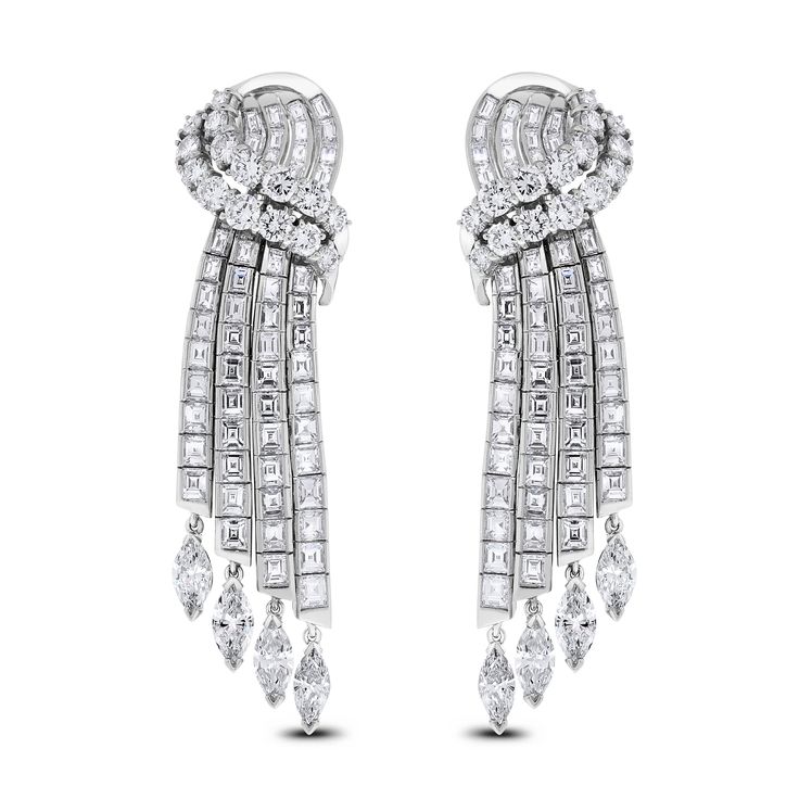 These classic channel set earrings exude luxury and extravagance. The are an ideal family heirloom or present for an important occasion. Diamond Shape: Round, Baguette & Marquise Total Diamond Weight: 14.75 ct Diamonds Color: G - H Diamonds Clarity: VVS - VS (Very Very Slightly Included - Very Slightly Included) Metal: 18K White Gold Metal Wt: 31.95 gms Setting: Prong & Channel Set Length: 2.4 Inches (6.10 cms) Omega Back Closure Diamond Waterfall Earrings, Unique Diamond Earrings, Heart Diamond Earrings, Classic Channel, Waterfall Earrings, Ideal Family, Pearl Chandelier Earrings, Diamond Chandelier Earrings, Pom Earrings