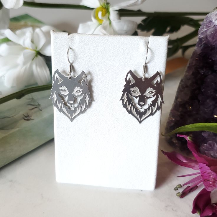 Intricately cut stainless steel wolf charms. Stainless steel Hooks Hypoallergenic Silver Stainless Steel Earrings, Silver Stainless Steel Drop Earrings, Gift Stainless Steel Drop Earrings, Sterling Silver Wolf Design Jewelry Gift, Sterling Silver Jewelry With Wolf Design For Gift, Silver Wolf Design Stainless Steel Jewelry, Silver Stainless Steel Wolf Jewelry, Silver Stainless Steel Wolf Design Jewelry, Sterling Silver Wolf Design Jewelry