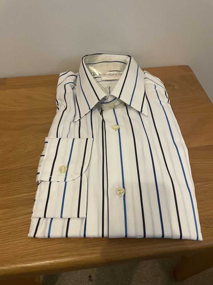 "Vintage unworn white shirt with dark and mid blue alternating striped pattern in pure Swiss cotton by Richard Jones London.  Details: soft banded spread collar, hand set double stitched twin needle seamed sleeves, single cuff, regular fit.  100% cotton Size 15\" 38 cm S/M" White Dress Shirt With Striped Collar For Work, Classic White Shirt With Signature Stripes, Classic Workwear Shirt With Contrast Stripes, Pinstripe Spread Collar Shirt For Office, Pinstripe Shirt With Spread Collar For Office, Office Pinstripe Shirt With Spread Collar, Semi-formal Striped Shirt With Striped Collar, Elegant Formal Shirt With Striped Cuffs, White Long Sleeve Shirt With Contrast Stripes