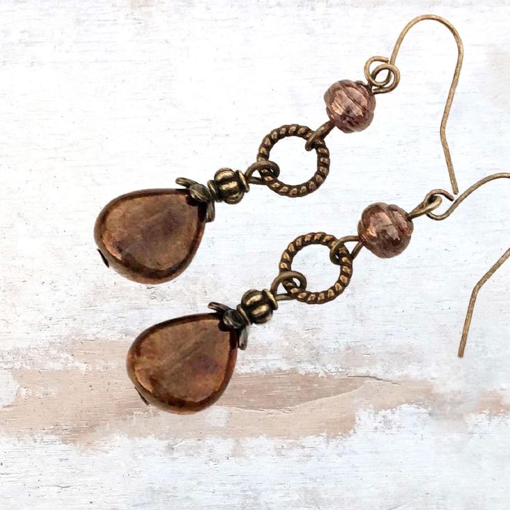 Earthy bronze glass teardrop earrings with rich natural earthy tones and depth of color. The translucent Czech glass beads have shades of brown and subtle reds. Enjoy the look of these unique bronze glass teardrop dangle earrings that will remind you of the forest and add an organic vibe to your outfit.  Easily go from day to evening with these versatile dangle bead earrings that were inspired by nature. - Hypoallergenic ear wires (nickel and lead free). Select ear wire style.   - Free gift pack Bohemian Jewelry Earrings, Dangle Bead Earrings, Necklaces Boho, Earrings Nature, Winter Earrings, Brown Earrings, Reno Nv, Bronze Jewelry, Teardrop Dangle Earrings