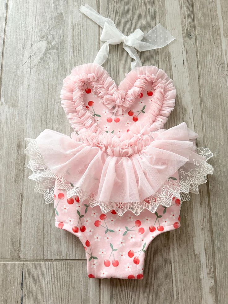 Baby romper great for cake smash sessions! Awesome birthday photo prop.  cherry themed!  Handmade  All sales final Halter top Stretchy  Pink, red and white This listing is for romper ONLY headbands to match now listed in my shop!  you need to add headband to your cart. https://spoonfuloffreckles.etsy.com/listing/1718582254 check out Maddie's little bracelets she is making listing in my Etsy shop. this listing is for romper only  cherry first birthday Sweet Fitted Bubble Romper For Spring, Sweet Pink Bubble Romper For Summer, Cute Bubble Romper For First Birthday In Spring, Cute Fitted Bubble Romper For First Birthday, Cute Bubble Romper For First Birthday In Summer, Ruffled Bubble Romper For First Birthday In Summer, Cute Fitted Summer Bubble Romper, Summer Ruffled Bubble Romper For First Birthday, Cute Fitted Bubble Romper For Spring