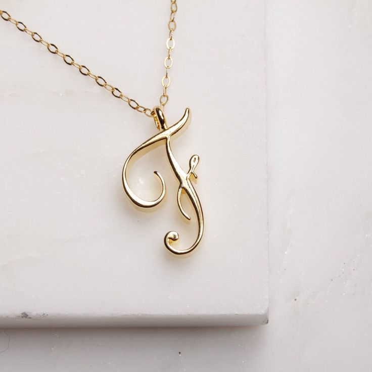 "F Initial Necklace - Cursive \"F\" initial gold pendant - Personalized initial gold pendant for women / Gift for her / for mom / for wife / Dainty \"F\" initial. Perfect every day necklace. Lovely gift for your self, sister, bridesmaids, new mom. Convo me if you would like to customize the length of the chain. The possibilities are endless. Pendant: Base metal is brass and 16K gold plated. Chain is 18 inches, 14k gold filled. (if you would like a longer or shorter chain, please contact us to cu Gold Monogram Initial Pendant Necklace, Elegant Gold Initial Necklace With Name Detail, Gold Initials Name Necklace As Gift For Mom, Gold Initials Name Necklace For Mom, Gold Initial Necklace For Anniversary Gift, Gold Initial Necklace As Mother's Day Gift For Her, Gold Initial Necklace For Mother's Day, Initial Pendant Charm Necklace For Anniversary, Gold Initials Charm Necklace As Gift For Mom