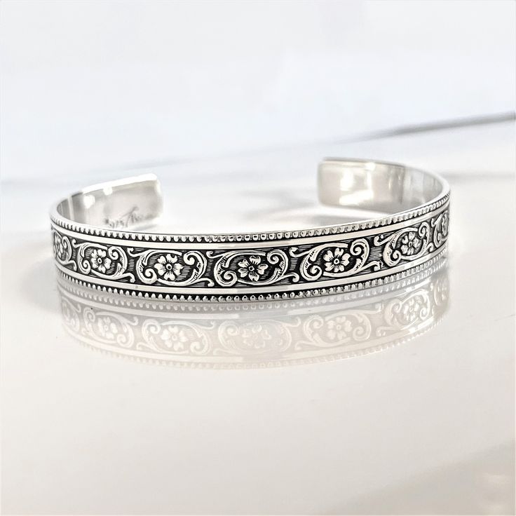 "Details:  - one 3/8\" width solid sterling silver cuff bracelet engraved with a floral motif on the outside - your choice of wording on the inside (175 Characters or less) - your choice of size (6\" is the most common size) - all cuffs can be adjusted with steady pressure to be made tighter or looser ~DON'T FORGET TO GRAB A SUNSHINE POLISHING CLOTH: https://www.etsy.com/listing/469627127/sunshine-cleaning-cloth-for-jewelry?ref=shop_home_active_1 CHECK OUT MY ENTIRE SHOP! https://www.etsy.com/shop/TatumBradleyCo?ref=si_shop" Western Fashion Jewelry, Secret Message Bracelet, Message Bracelet, Cuff Jewelry, Sterling Silver Cuff Bracelet, Personalized Bracelets, Sterling Silver Cuff, The Groom, Silver Cuff Bracelet