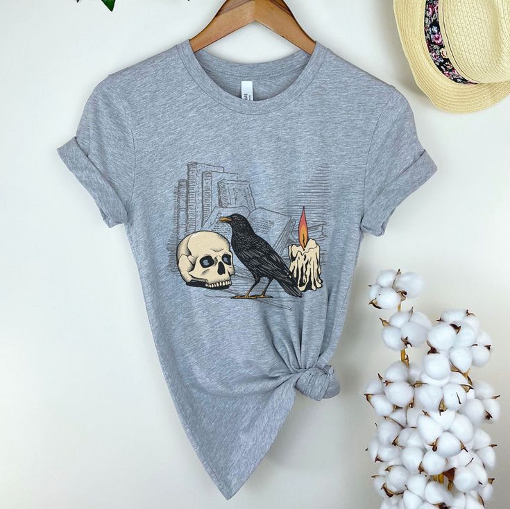 Bookish Tribute to one of the great horror authors of all time: Edgar Allen Poe - 100% cotton (fiber content may vary for different colors) - Medium fabric (6.0 oz/yd² (203 g/m -Classic fit -Tear-away label -Runs bigger than usual. Available in sizes S-2XL -T-shirt Brand Gildan 2000 HOW TO CARE FOR YOUR GARMENT: Wash items inside out in cold water to preserve the print and color longer. Cotton shirts may shrink in the dryer if the heat is set high. Please do not bleach, do not dry clean and do not iron directly on the design. SIZE GUIDANCE: SIZE   Length (inches) Width (inches)  S                 28.5                     18.5 M                29.5                     20.5                  L                 30.5                     22.5                  XL               31.5 Literary Black Cotton T-shirt, Literary Cotton Relaxed Fit T-shirt, Literary Style Cotton T-shirt With Relaxed Fit, Cotton Horror T-shirt With Skull Print, Cotton Horror Crew Neck Shirt, Scary Novels, Literature Shirt, Edgar Allen, Gift For Book Lover