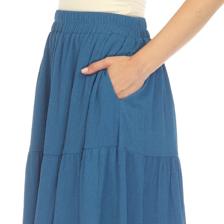 Elevate your fashion game with this flowy and effortlessly chic skirt. This maxi skirt from White Mark boasts a pleated design that adds texture, movement, and a touch of sophistication to your look. Dress it up or down as this skirt is incredibly versatile. Pair it with a tucked in blouse and heels for a sophisticated look or go for a more relaxed vibe with a tucked in tee and sandals and pair it with a jacket on chilly days. It’s perfect for various occasions and style preferences. Flowy Wide Leg Maxi Skirt For Day Out, Spring Rayon Maxi Skirt With Gathered Details, Spring Tiered Maxi Skirt In Rayon, Flowy Solid Pleated Skirt, Spring Flowy Gathered Maxi Skirt, Flowy Gathered Maxi Skirt For Spring, Chic Flowy Rayon Maxi Skirt, Rayon Maxi Skirt For Day Out, Rayon Tiered Maxi Skirt For Day Out