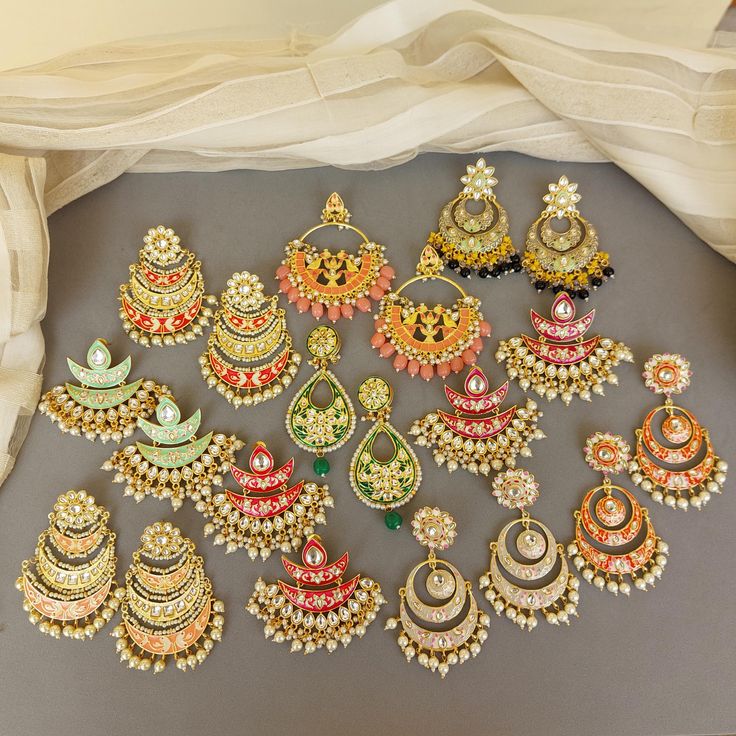 A pair of golden-toned Hand Painted Traditional Meenakari Earring for Saree.  Size & Other Details Material : Brass, Pearl, Meena work Shape : Flower Shaped Attire : Lehenga Choli, Salwar Suit, Kurti, Saree, Flared Dress FYI: Assorted designs will come depending on the stock available. 5 color left Shop more: https://www.etsy.com/shop/FashionCrabIndia/ Style Tip ---------------------------- Elevate your traditional outfits with our unique collection. Perfect for festivals. Care Tips ------------ Temple Jewelry Kundan Chandbalis With Motifs, Traditional Meenakari Chandbalis, Traditional Meenakari Hoop Earrings For Diwali, Traditional Meenakari Hoop Earrings For Festive Occasions, Gold Meenakari Chandbalis For Festivals, Traditional Kundan Hoop Earrings With Meenakari, Traditional Kundan Jhumkas With Motifs, Traditional Hoop Earrings For Navratri Gift, Traditional Kundan Chandbalis With Motifs