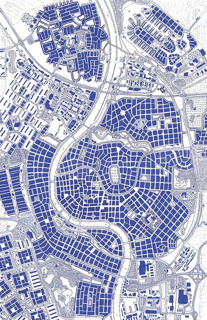 an aerial view of a city with lots of buildings and streets in blue ink on white paper