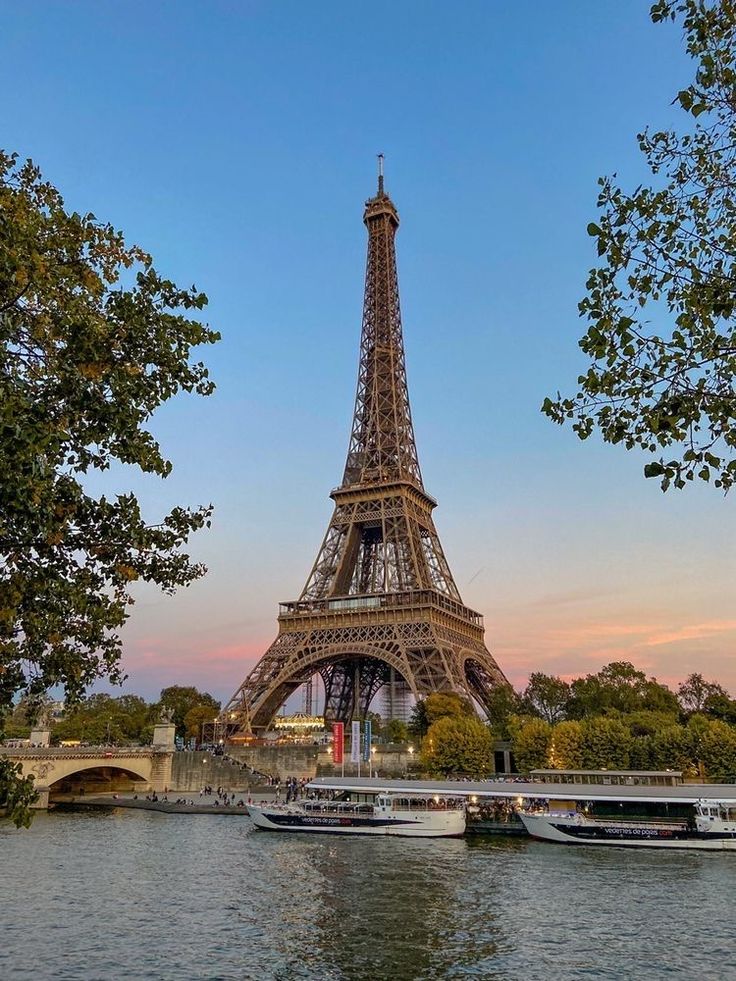 the eiffel tower towering over the river seine in paris, france at sunset