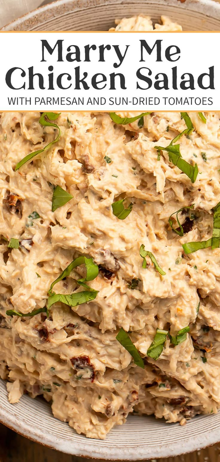 a bowl full of chicken salad with parmesan and sun - dried tomatoes on top