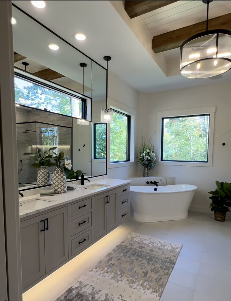 a large bathroom with two sinks and a bathtub in the middle of the room