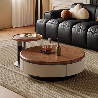 a living room with black leather couch and coffee table