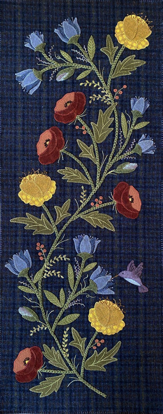 an embroidered piece with flowers and birds on it's back side, in blue fabric