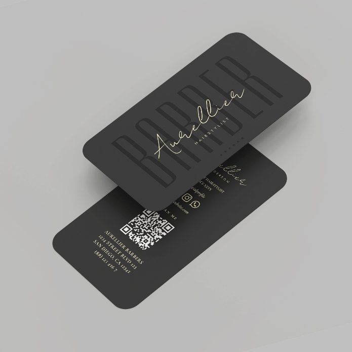 two black business cards with gold foil lettering on the front and back, sitting side by side