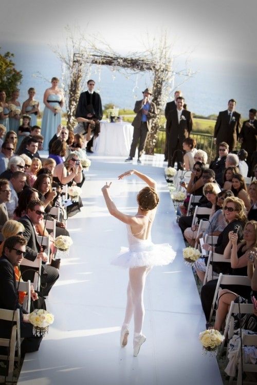 a ballerina is performing in front of an audience at a wedding ceremony with the bride and groom watching