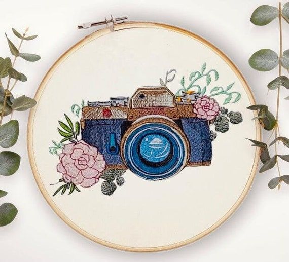 an embroidery project with a camera and flowers