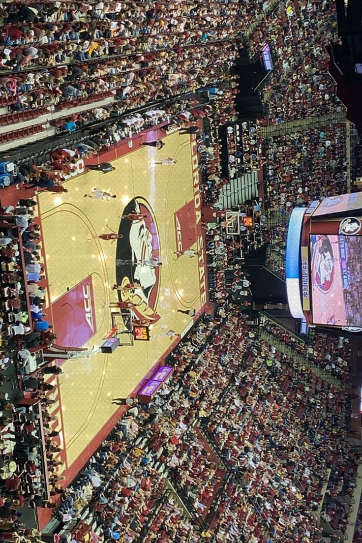 an overhead view of a basketball court with fans in the stands at a sporting event