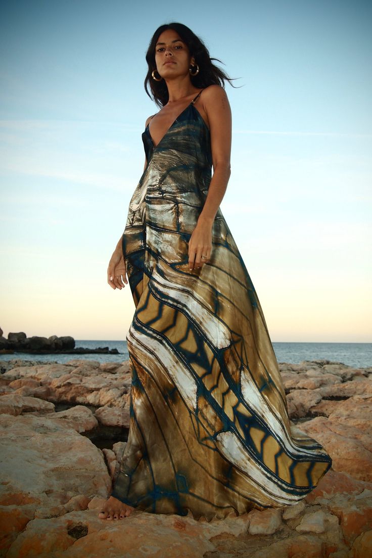 The Xarracca dress with Freya print is a beautiful, elegant new maxi dress from the MONA SWIMS TITAN collection. It has a mineral-inspired print, designed in-house and made of light, airy, flowing silk and features slim, elegant leather straps that can be tied in the back or belted in the front. This dress transforms beautifully from day to night. Wear it as evening wear or as luxurious beach wear. Each piece has a totally unique print, as no two pieces are cut exactly the same. 100% Light Airy Luxury Beachwear, Silk Cape, Raffia Crochet, Goddess Gown, Silk Kaftan, Night Wear, Home Dress, Silk Maxi Dress, Petite Dresses