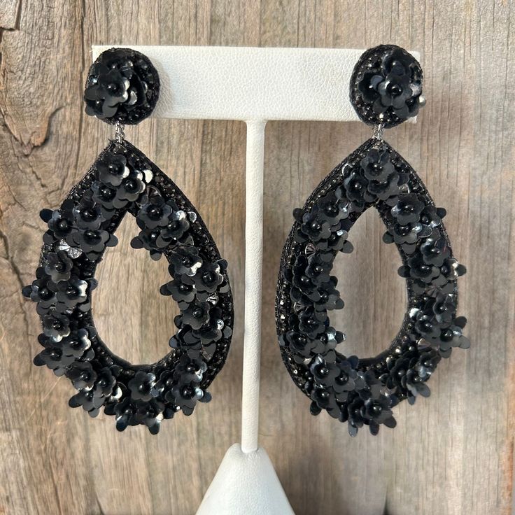 "Deepa Gurnani Black Beaded Earrings These beautiful earrings come from designer Deepa Gurnani. They have elegant Black glass beads in a and sequins statement earring design with large teardrop shaped hoops. The backing is done in a vegan leather. These are high quality statement earrings that are in \"like new\" shape. They are finished off with nickel free post backs for an attractive dangle drop on the ears. Length:  3 inches Width:  1-3/4 inches   Weight:   16 grams **Returns:  No returns except on items that arrive damaged. Please review the pictures and description provided.  However, I will consider exercising flexibility on other issues when possible. Please don't hesitate to contact me with questions you may have before purchase. Thank you!" Handmade Teardrop Beaded Earrings For Parties, Elegant Teardrop Beaded Earrings For Party, Beaded Dangle Chandelier Earrings For Party, Party Beaded Drop Earrings, Dangle Beaded Earrings For Party, Embellished Dangle Beaded Earrings For Party, Embellished Beaded Dangle Earrings For Party, Elegant Beaded Hoop Earrings For Party, Festive Teardrop Beaded Earrings With Dangling Beads