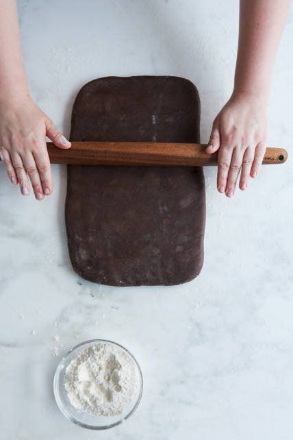 a person rolling dough on top of a counter